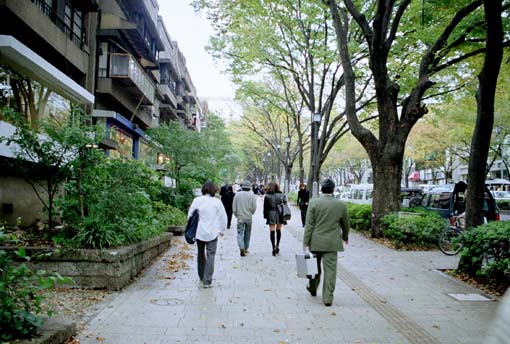 people walking next to apartment building